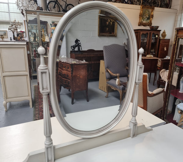 French Louis XVI style painted dresser / console with beveled oval mirror and three drawers. Sourced from France and in good original detailed condition.