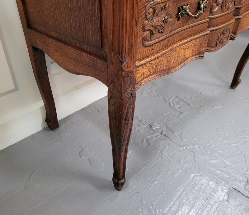 Vintage French dark Oak Louis XV style chest of three drawers. It has beautiful cabriole legs, elegant brass handles and decorative carving throughout. It is in good original detailed condition and has been sourced from France.