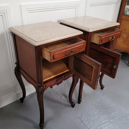 Pair of French Antiloopque Louis XV style Walnut and marble top bedsides. They have lovely carvings along with a drawer and cupboard space. They are in good original detailed condition and have been sourced from France