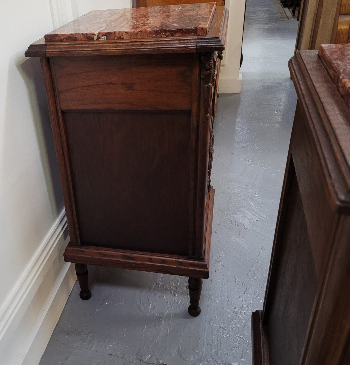 Pair of French Art Deco Oak and rouge inset marble top bedside cabinets. They have one drawer and one cupboard with elegant carving on the door. They have been sourced from France and are in good original detailed condition.