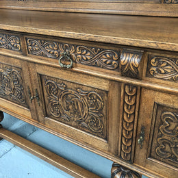 French Oak beautifully carved Renaissance style sideboard with four drawers. Beautiful wax finish and is in good original detailed condition.