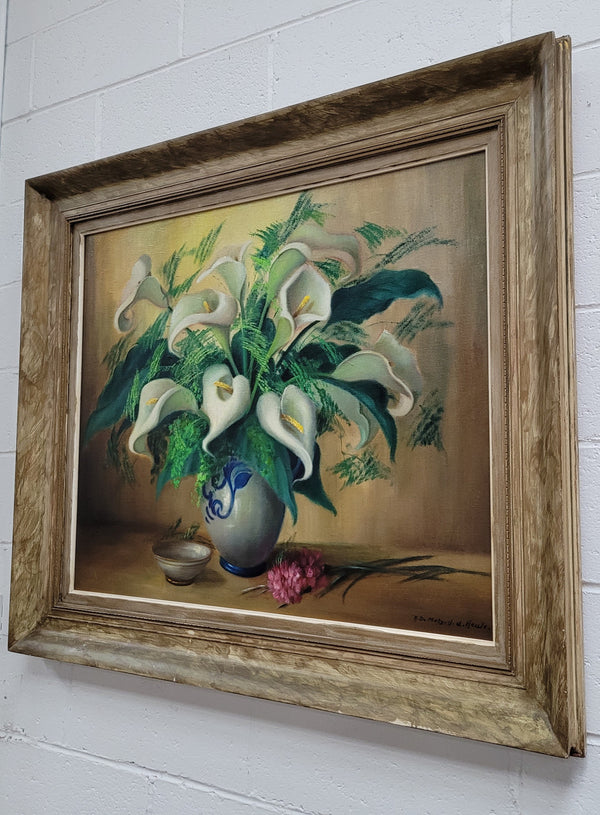 Signed and sourced in France a vintage oil on board still life of white lillie's in vase. In a beauitufl frame and it is in good original detailed condition.