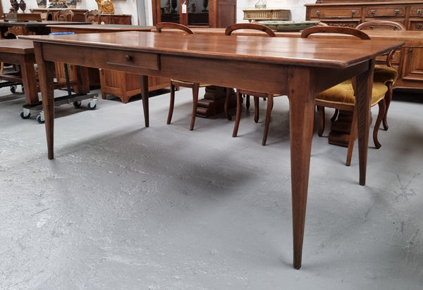 Antique French Oak Farmhouse table in fully restored condition. Features a single drawer and tapered legs.