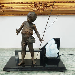 An amazing French Art Deco boy fishing statue with a Vaseline light shade. It is in fantastic working condition on a lovely marble base.