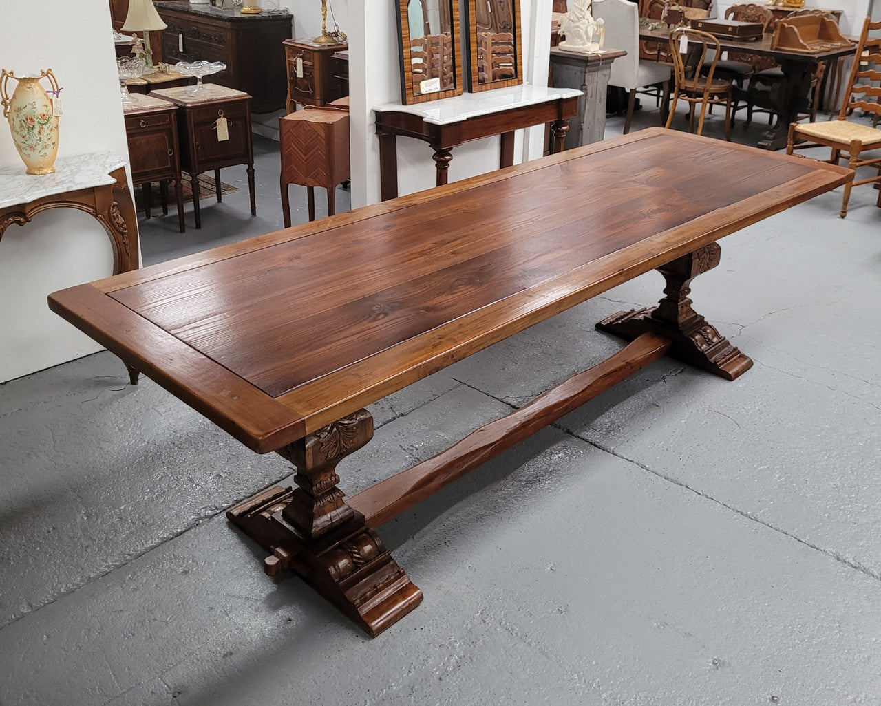 French style reclaimed Elm Farmhouse table with stretcher base and amazing carving underneath. Table can sit 10-12 people and is in good original detailed condition.