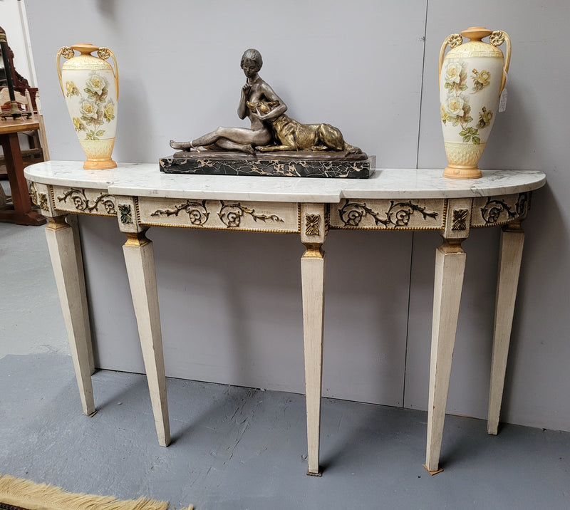 French Louis XVI style painted marble top console table. It is of pleasing narrow proportions and has been sourced from France. It is in good original detailed condition.