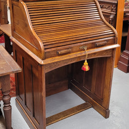 Charming petite English Oak fitted roll top desk. It has a very lovely fitted interior and a drawer at the front ideal for a unit or apartment. Sourced locally and in good original detailed condition.