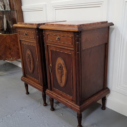 Pair of French Art Deco Oak and rouge inset marble top bedside cabinets. They have one drawer and one cupboard with elegant carving on the door. They have been sourced from France and are in good original detailed condition.