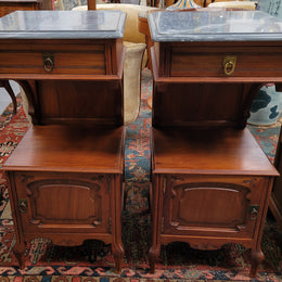 Pair of unusual transitional fruit wood marble top bedside cabinets. They have been sourced from France and are in good original detailed condition.