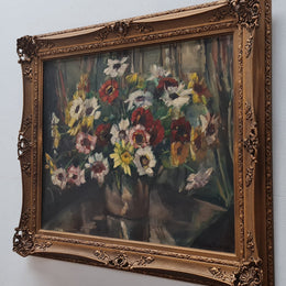 Sourced in France is this beautiful floral oil painting on canvas and framed in a lovely decorative frame. It is in good original condition.