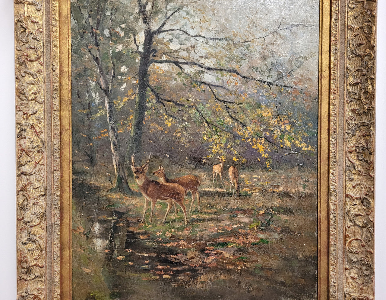 Charming oil painting on canvas depicting a forest scene and deer in an ornate gilt frame. In good original detailed condition.