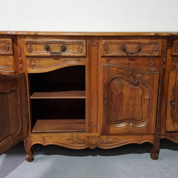 A Beautifully carved French Walnut Louis XV style four door sideboard. Plenty of storage space with four doors as well as four drawers. It is in good original detailed condition.