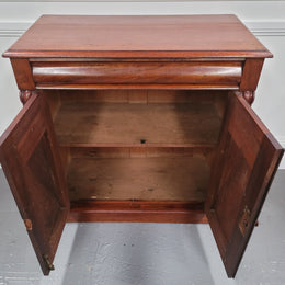 Cedar side cabinet with two doors one drawer and lovely door panels and corbels. It has been sourced locally and is in good original detailed condition.