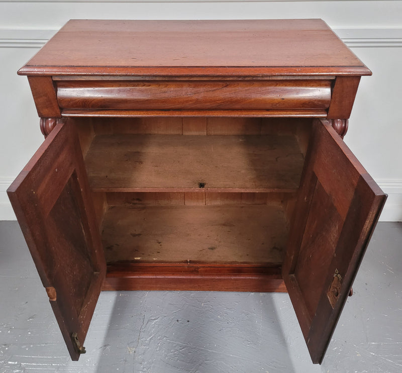 Cedar side cabinet with two doors one drawer and lovely door panels and corbels. It has been sourced locally and is in good original detailed condition.