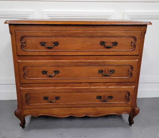 French Louis 15th style Oak three drawer chest of drawers with wooden top. It has been sourced from France and is in good original detailed condition.