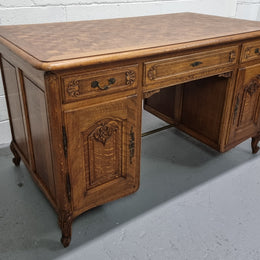 Fabulous French oak carved partners desk with a lovely parquetry top. It has three drawers and two cupboards on one side and two cupboards on the other side with no functioning drawers. It is in good original detailed condition.