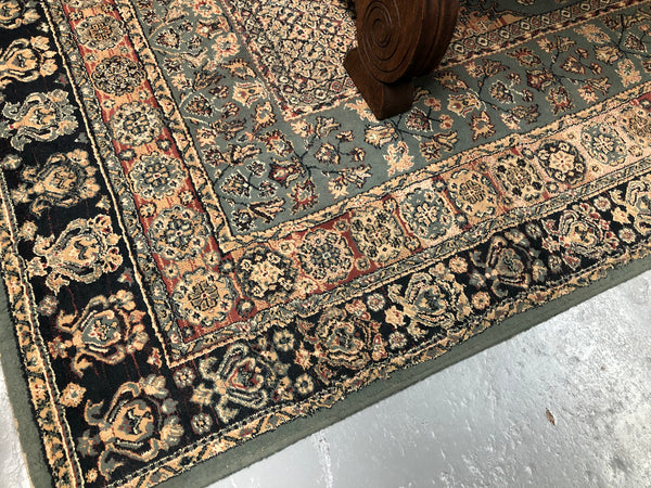 A beautiful coloured Turkish Rug with shades of green, teal, navy and rust in good condition.