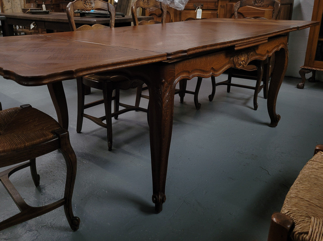 French Oak Louis XV style parquetry top extension table. It can sit six people when not extended and eight when fully extended. It has been sourced from France and is in original detailed condition.