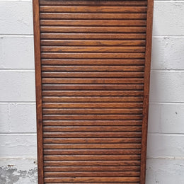 Antique Edwardian roll top Tambour file cabinet desk. This practical antique tambour front filing cabinet dates around 1900 in the Edwardian period and is constructed from Oak. This antique cabinet has an adjustable writing slope, above a tambour front with key and working lock. It has been sourced locally and is in good original detailed condition.
