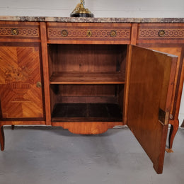 A high quality 19th Century French marquetry inlaid Kingwood marble top credenza. It has an attractive solid marble top and decorative marquetry inlay throughout. It has plenty of storage space with three drawers and three doors. It has been sourced from France and is in good original detailed condition.