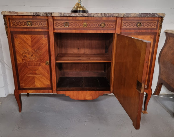 A high quality 19th Century French marquetry inlaid Kingwood marble top credenza. It has an attractive solid marble top and decorative marquetry inlay throughout. It has plenty of storage space with three drawers and three doors. It has been sourced from France and is in good original detailed condition.
