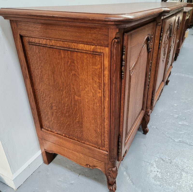 French oak large, beautifully carved four door sideboard with lockable doors and plenty of room for storage in good original condition.