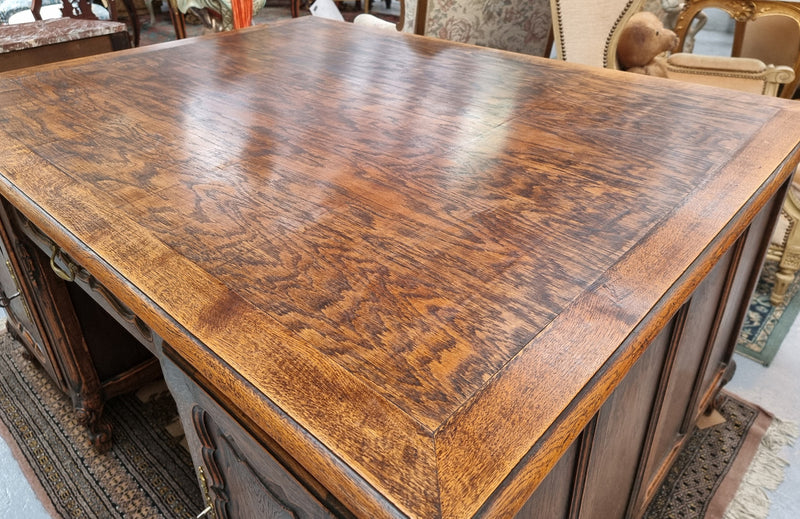 Fabulous Louis XV style French Oak beautifully carved full partners desk. Both sides have a functioning drawer in the middle and two cupboards either side. On both sides one cupboard door opens up to four smaller internal drawers. Plenty of storage space and a large top surface to work on. It is in good original detailed condition.