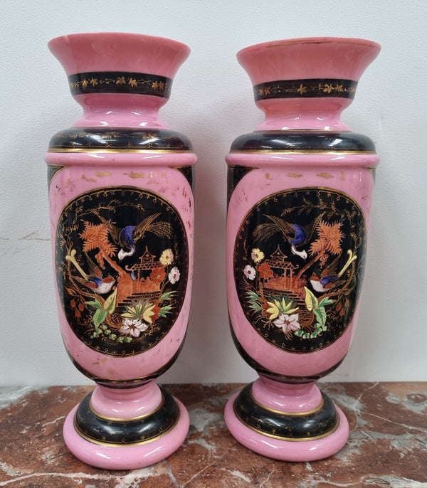 Late Victorian pink and hand painted, enameled pair of vases with some ware to enameling. It is in good original condition.