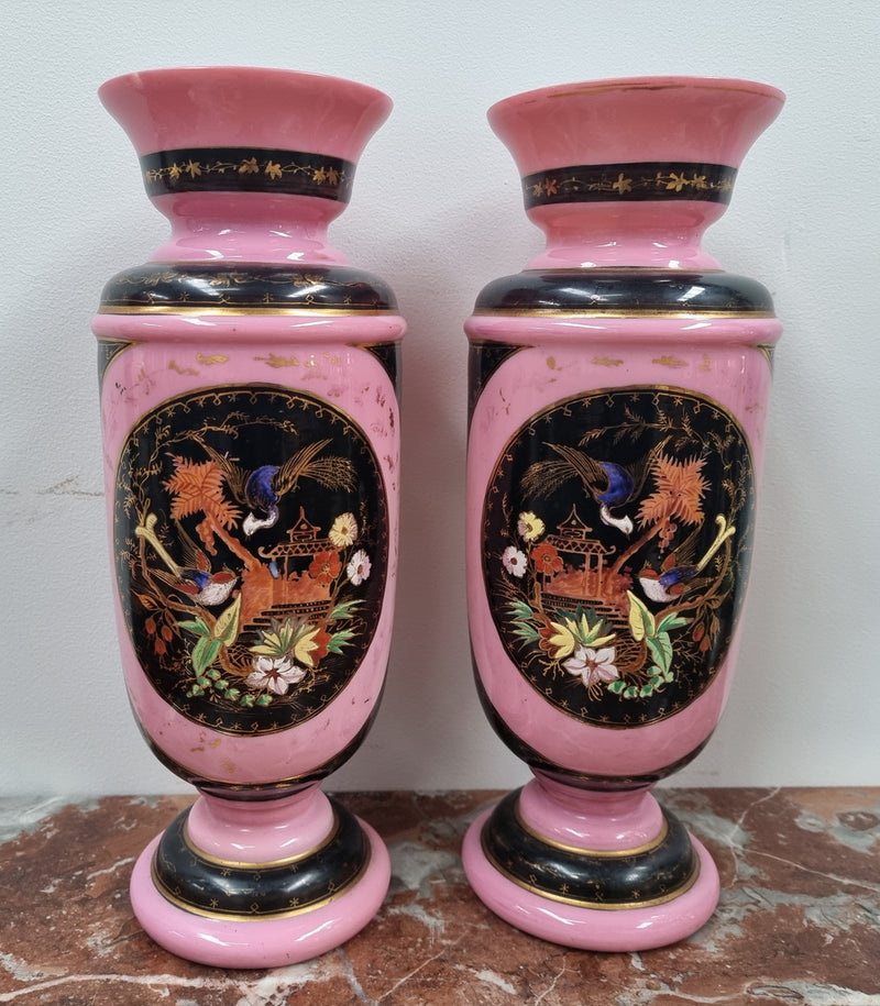 Late Victorian pink and hand painted, enameled pair of vases with some ware to enameling. It is in good original condition.