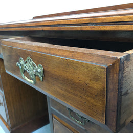 Fabulous small size walnut desk, with nine drawers and decorative brass handles and in good original condition.