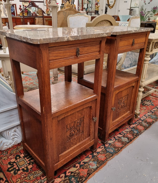 Charming pair of French Oak Arts and Crafts bedsides with shelf, cupboard with carving and marble top.  They have been sourced from France and are in good original detailed condition.