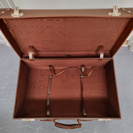 Impressive solid leather suitcase, moire fabric lined with leather straps to hold contents. Displays gold initials F.S.A near handle. With key. Please view photos as they help form part of the description.
