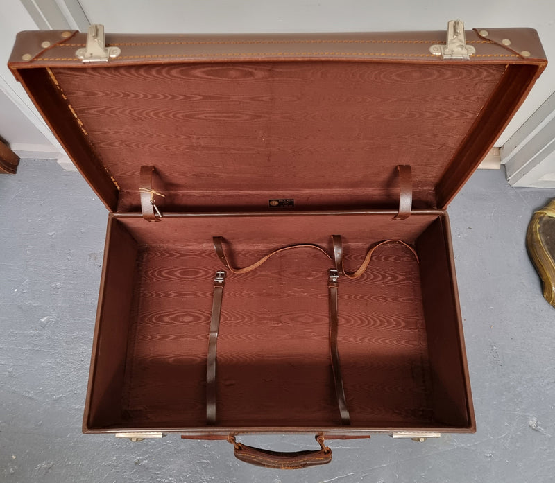 Impressive solid leather suitcase, moire fabric lined with leather straps to hold contents. Displays gold initials F.S.A near handle. With key. Please view photos as they help form part of the description.