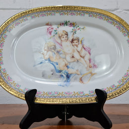 Beautiful T. Limoges porcelain decorative oval plate depicting 3 cherubs with gold edging. In good original condition.