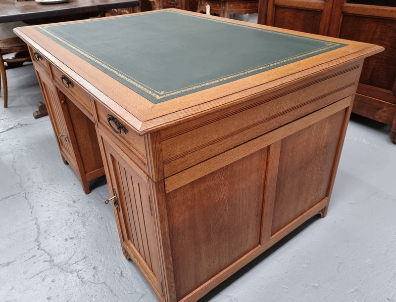 French Oak Art Deco full partners desk with leather top. Plenty of storage with both sides having three drawers at the top and two cupboards on both sides, one side has a filing section with three internal drawers and the other has a shelf on one side with three internal drawers as well. In good original detailed condition.