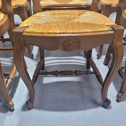 Set of six French Louis 15th style rush seated dining chairs. They are comfortable to sit in and are in original condition.