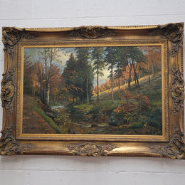 Large signed oil on canvas depicting a river stream in autumn framed in a stunning gilt frame. Sourced from France and is in good original detailed condition.