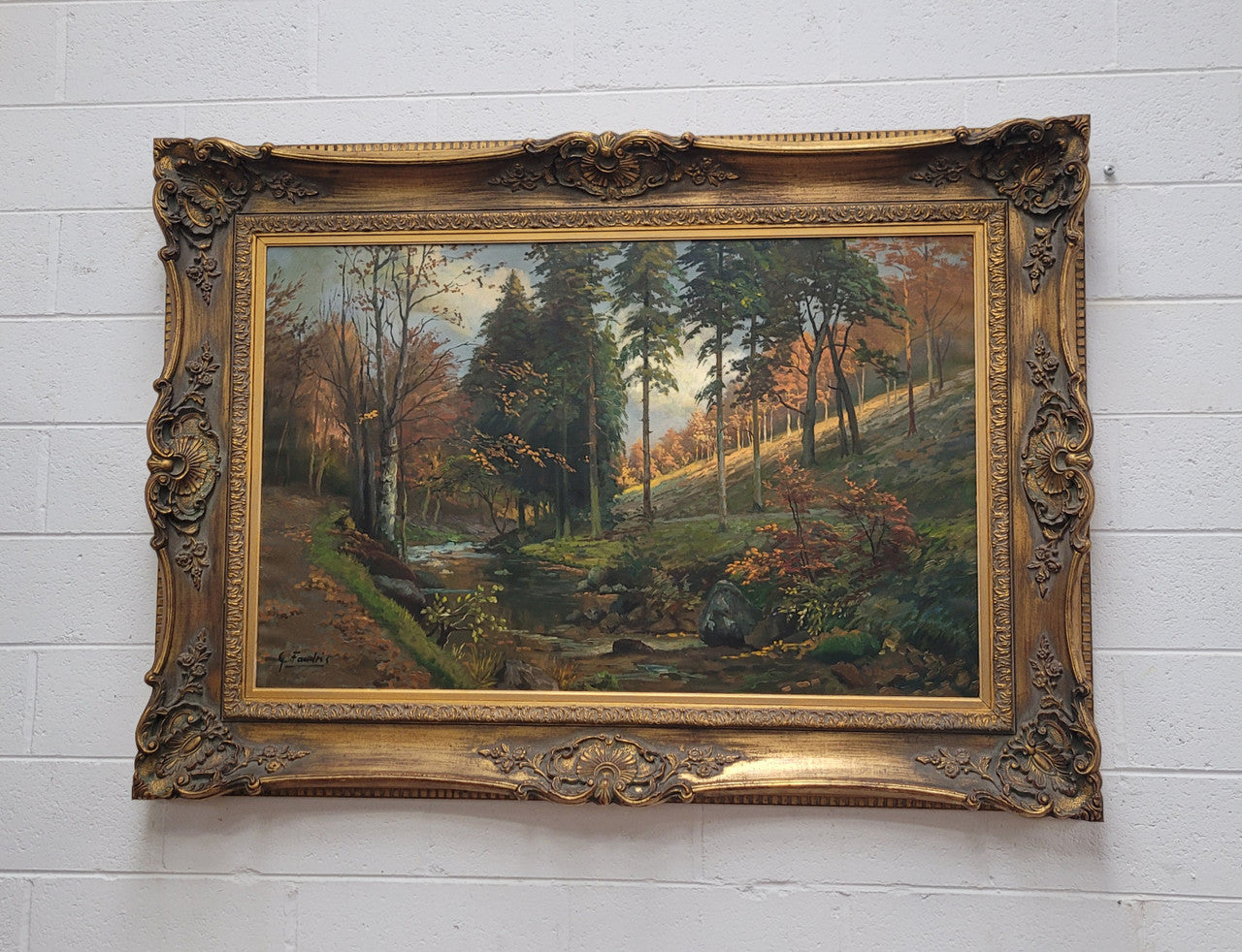 Large signed oil on canvas depicting a river stream in autumn framed in a stunning gilt frame. Sourced from France and is in good original detailed condition.