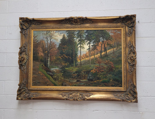 Large signed oil on canvas depicting a river stream in autumn framed in a stunning gilt frame. Sourced from France and is in good original detailed condition.