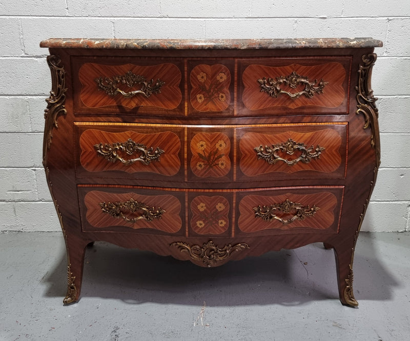 French Walnut and Kingwood Louis XV style marquetry inlaid commode with three drawers and a beautiful marble top. It is in good original detailed condition.