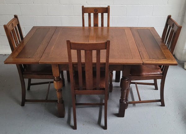 Fabulous small Oak extension table and four dining chairs. The table extends from a four seater to a six seater. The chairs have nice carvings and leather inset seats. They are in original detailed condition.