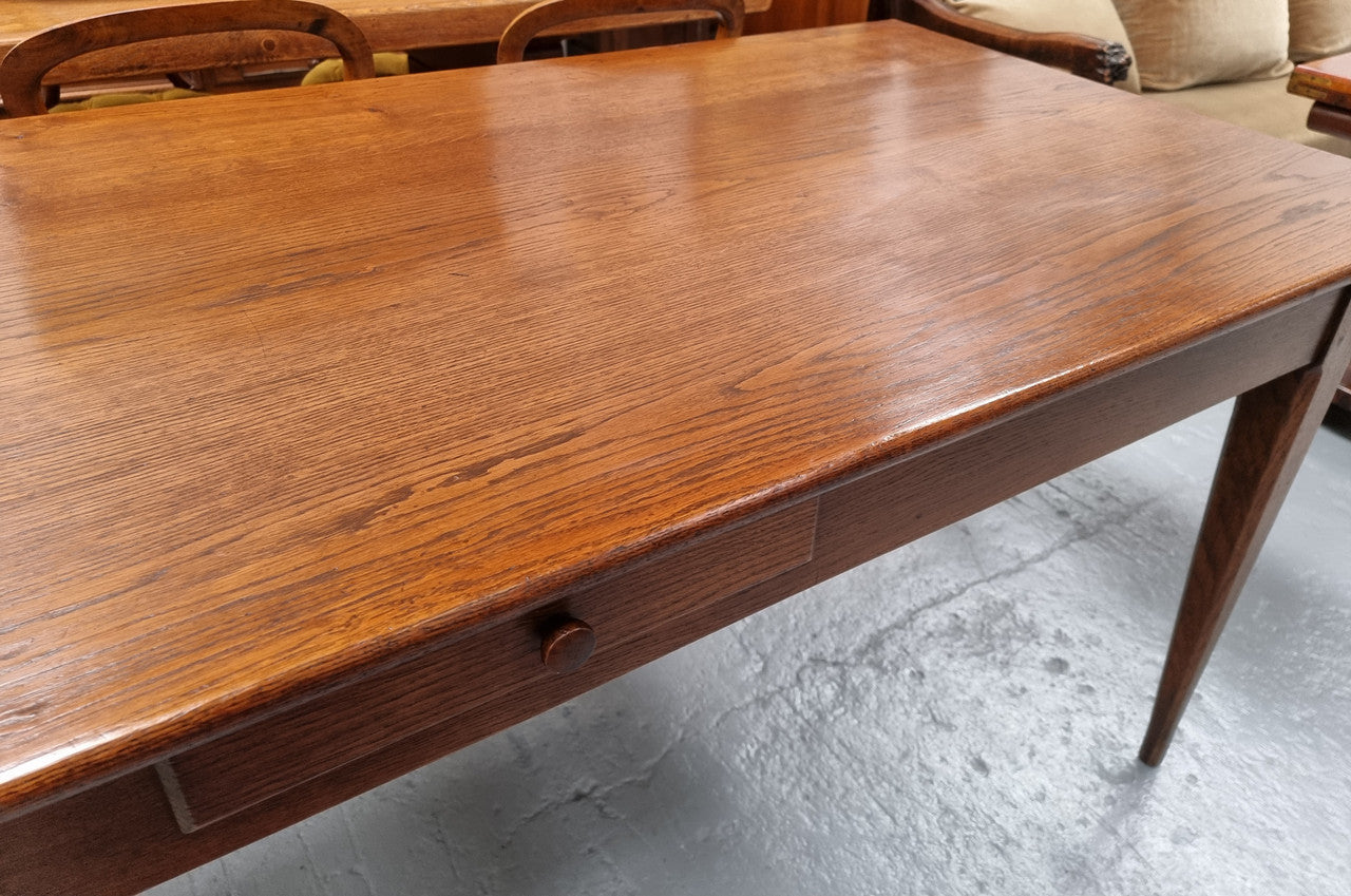 Antique French Oak Farmhouse table in fully restored condition. Features a single drawer and tapered legs.