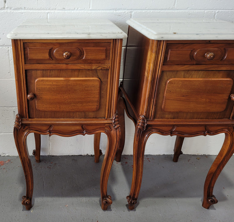 Pair of stunning Louis XV style French Walnut white marble top bedside cabinets. They have one drawer and a cupboard that is marble lined. The marble has been polished and they are in good original detailed condition.