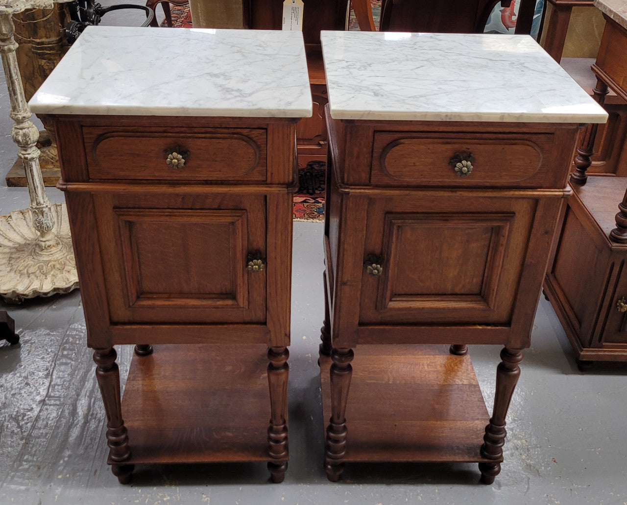 Antique French Oak Henry II white marble top bedside cabinets. They have one drawer and cupboard a long with an open shelf at the bottom. Sourced from France and in good original detailed condition.