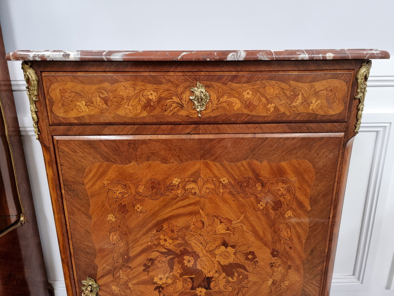 Elegant French transitional style Walnut & Kingwood Salon cabinet. It has beautiful marquetry inlay, a marble top and decorative ormolu mounts. Sourced From France and is in good original detailed condition.