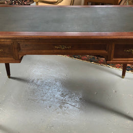 Lovely French Mahogany Louis XVI style leather top desk. With beautiful ormolu details and three drawers. There are also two slides on either side with tooled leather tops and in good original detailed condition.