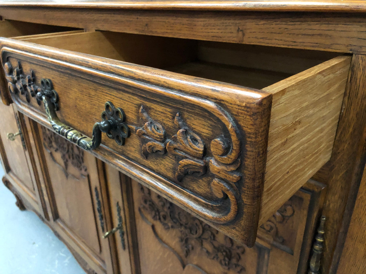 French Louis XV style Oak sideboard with beautiful carvings. Plenty Of storage space with four cupboards and two drawers. In very good original detailed condition.