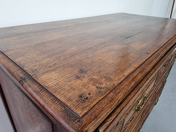 Early 19th Century French Oak chest of three drawers. It has beautiful handles and carvings. It is in good original detailed condition.