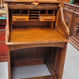 Charming petite English Oak fitted roll top desk. It has a very lovely fitted interior and a drawer at the front ideal for a unit or apartment. Sourced locally and in good original detailed condition.