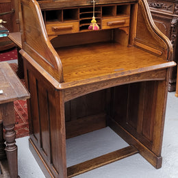 Charming petite English Oak fitted roll top desk. It has a very lovely fitted interior and a drawer at the front ideal for a unit or apartment. Sourced locally and in good original detailed condition.